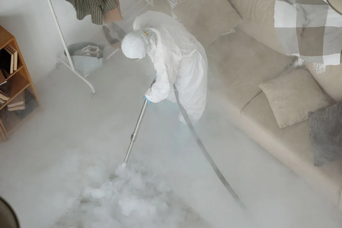 Biohazard cleanup technician in protective equipment, Glidden, TX
